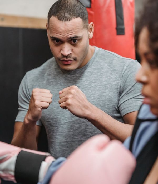Athletic man in a powerful stance demonstrating physical control.