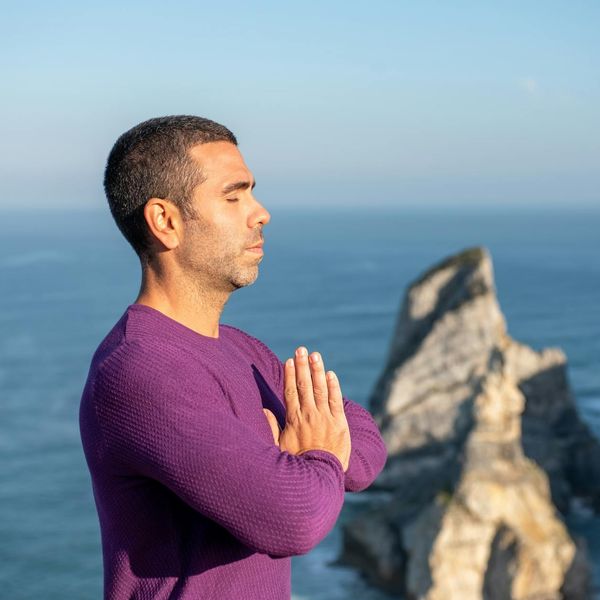 Man meditating peacefully outdoors, showing mental clarity.